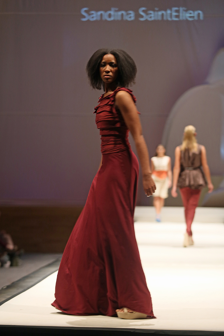 Syracuse University senior Sandina SaintElien (CQ)  designed a dress shown at the SU Senior Collection Fashion Show at Goldstein Auditorium. The annual show presents the work of seniors in the College of Visual and Performing Arts fashion design program.  Gloria Wright | Syracuse New Times 