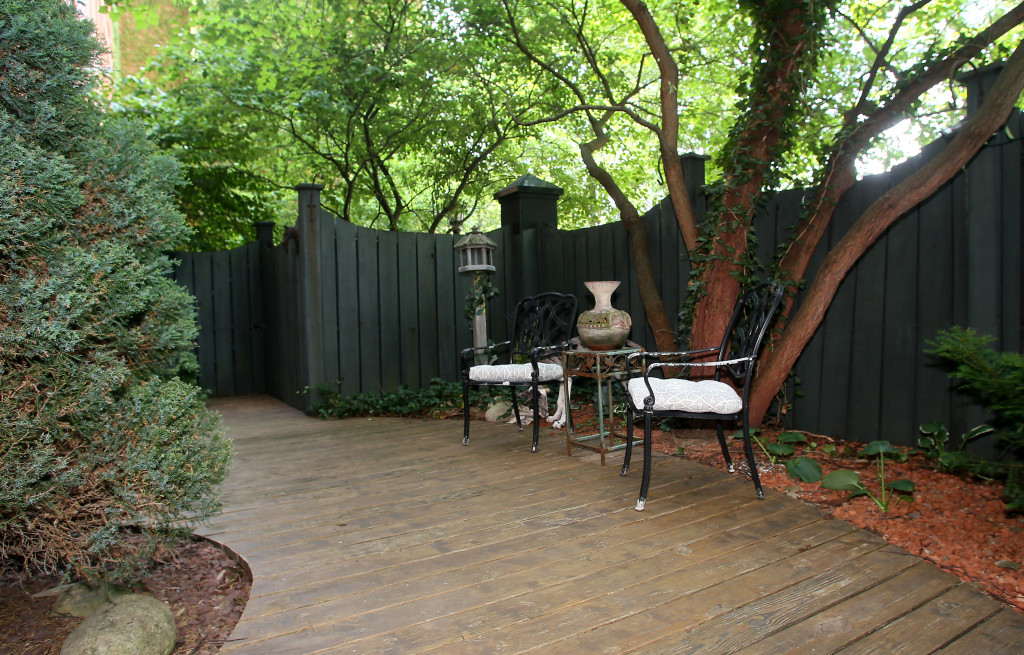 A patio shaded by large trees is accessed from the master bedroom at a Mission Landing condo. Photo by Gloria Wright