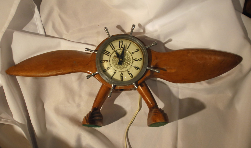 A clock shaped like an airplane propeller is available at Syracuse Antiques Exchange for $45.
