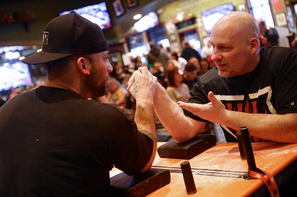 CNY Arm Wrestlers coach, Chris Myers, gives tips and pointers during Battle of Arms III: Judgement Day. Michael Davis Photo | Syracuse New Times