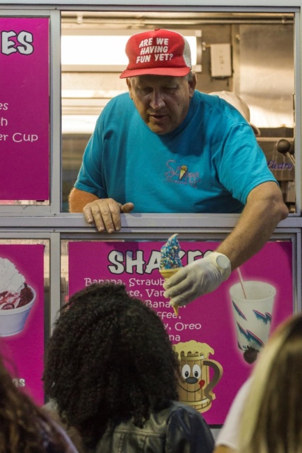 A man hands a patron an ice cream cone from a food truck at Wing Fest 2018