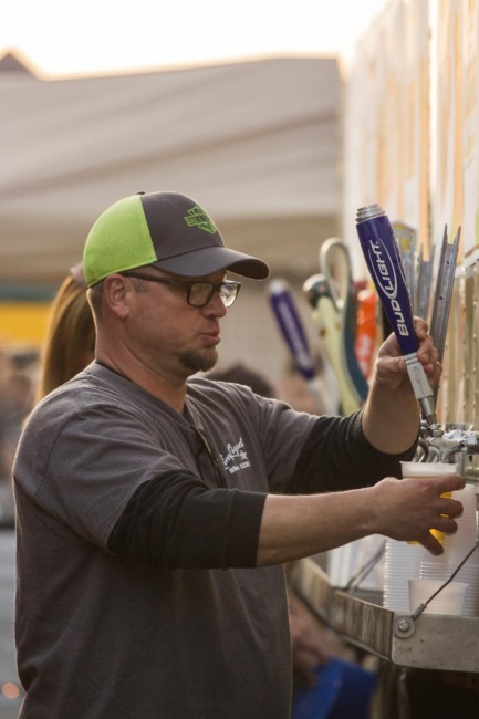 A man pulls a beer tap handle at Wing Fest 2018