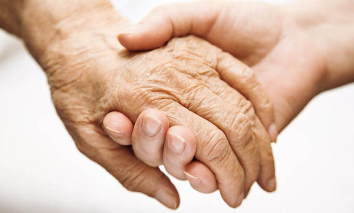 A-young-hand-holding-an-elderly-hand-665-x-400