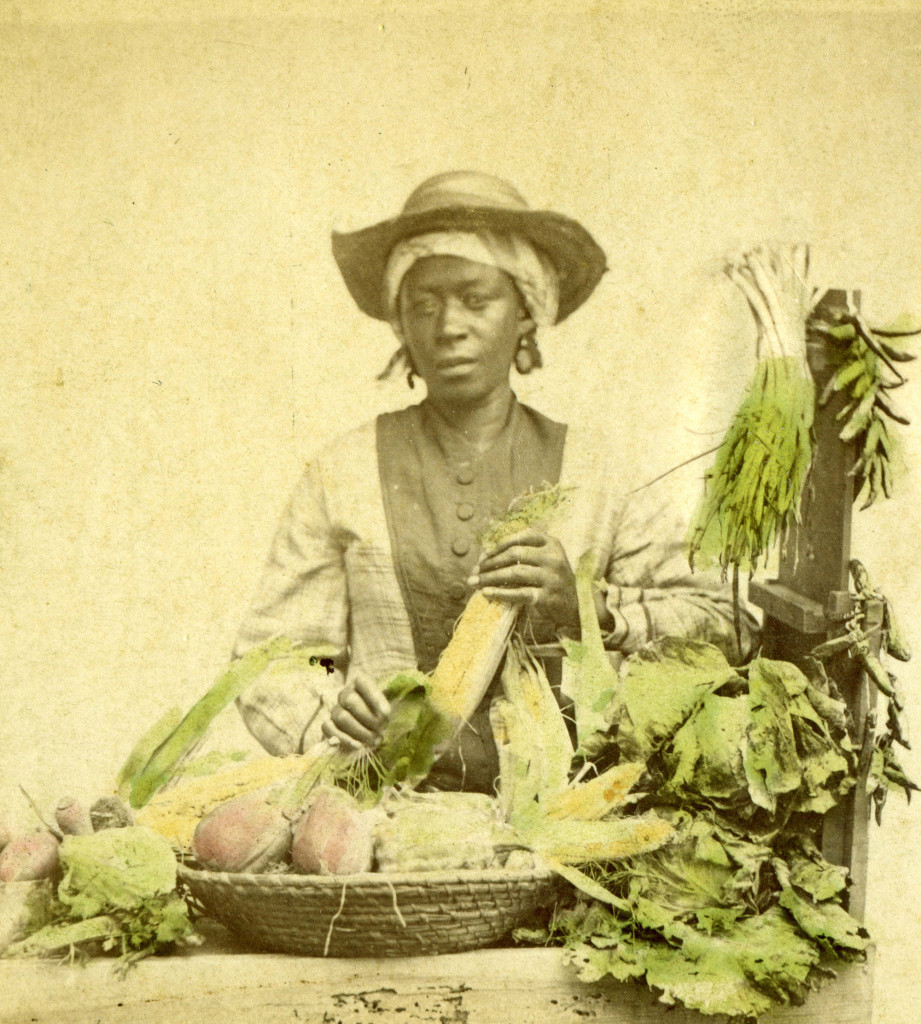 Black Girl with basket of vegetables shucking corn