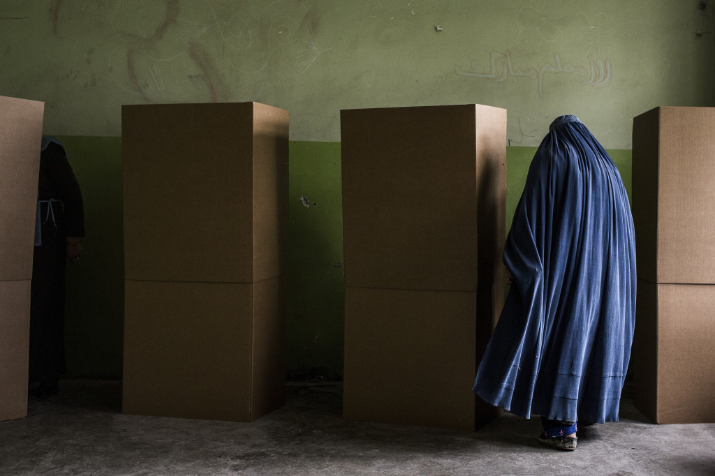 A voter prepares to fill out her ballot at a school in Kabul, Afghanistan. Bryan Denton | The New York Times