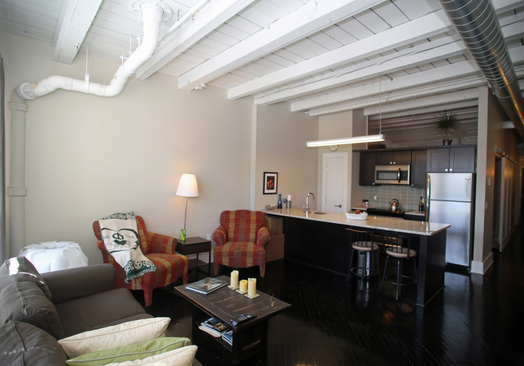 The kitchen and living room in the Pike Block project. (Gloria Wright Photo | Syracuse New Times)