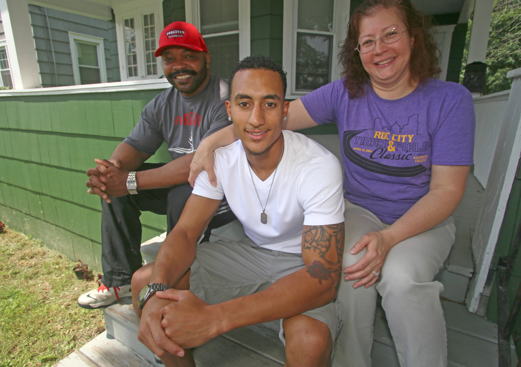 Will Dowdell, from left, Wendall Williams and Claudinne Clarke on the front steps of Clarke's home on Glenwood Avenue. Michael Davis Photo | Syracuse New Times