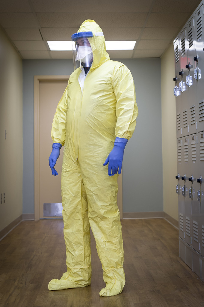 A Tampa General Hospital staff member in a full-body protective suit, which would be worn by medical staff when treating a patient infected with Ebola, in Tampa, Fla., Aug. 13, 2014. The Centers for Disease Control and Prevention released this month the first extensive guidelines for hospitals on how to treat Ebola patients, including the handling of bodily fluids and proper attire when treating patients. (Jock Fistick/The New York Times)