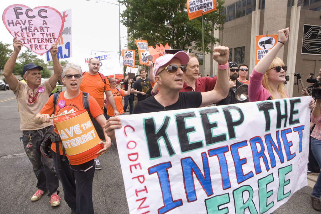 Before the Open Commission Meeting to vote on net neutrality was held at the FCC headquarters in Washington DC, protestors marched out front.  Photo Credit: Daniel Rosenbaum for The New York Times.                                 