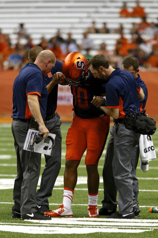Quarterback Terrel Hunt being helped off the field. Michael Davis Photo | Syracuse New Times