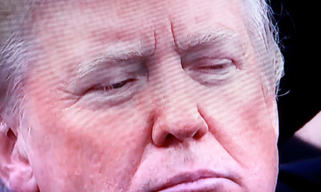 A close-up photo of President Donald Trump's face. He and his administration has encouraged an attack on journalism since before his election.