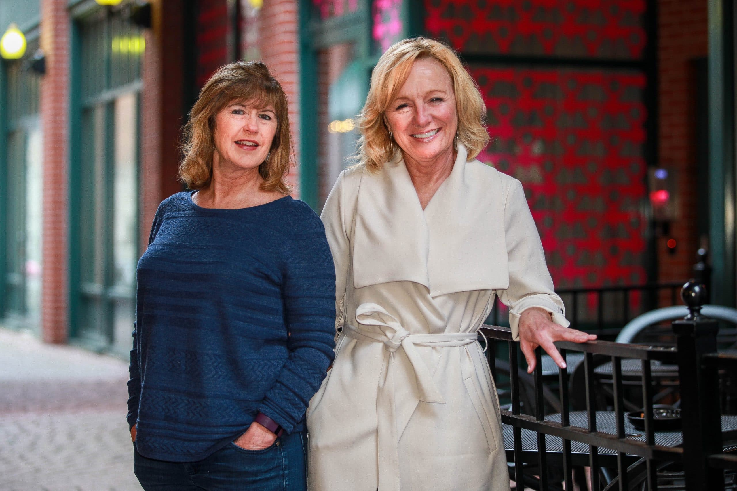 Two women, the creators of the Cut to the Chase dating app, stand facing the camera.