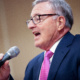 A close-up shot of Sen. John DeFrancisco as he speaks into a microphone.