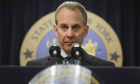 Former NY attorney general Eric Schneiderman stands behind a podium.