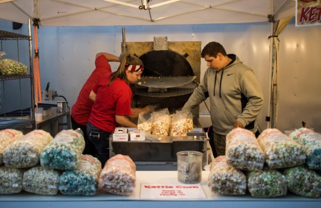 Two people are bagging popcorn at Wing Fest 2018. Other food vendors were also on-site.