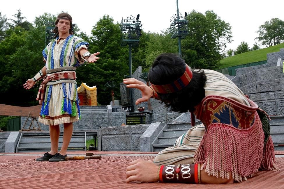 Two men in ancient clothing, indicative of the early AD era, present a theater play about Jesus Christ.