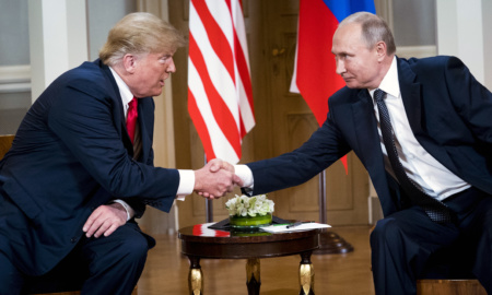 President Trump and Vladimir Putin shake hands during a press conference following their Helsinki Summit meeting.