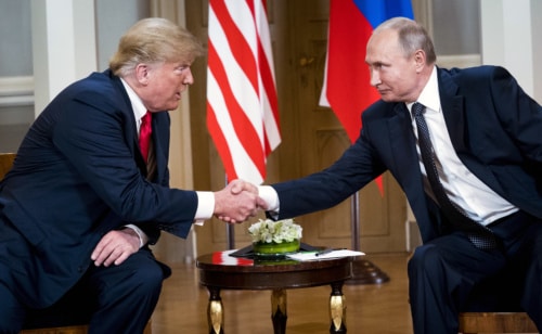 President Trump and Vladimir Putin shake hands during a press conference following their Helsinki Summit meeting.